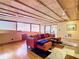 Living room with hardwood floors, exposed beams, and orange sectional at 2741 Edwards Rd, Haines City, FL 33844