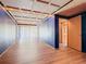 Hallway with blue walls, wood floors, and doors to other rooms at 2741 Edwards Rd, Haines City, FL 33844
