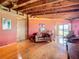 Living area with wood floors, exposed beams, and a view from large windows at 2741 Edwards Rd, Haines City, FL 33844
