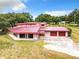 Single-Gathering home with red metal roof and attached garage at 2741 Edwards Rd, Haines City, FL 33844