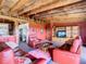 Spacious living room with exposed wooden beams, brick floors, and comfortable leather furniture at 2741 Edwards Rd, Haines City, FL 33844