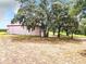 Property features a large building with mature oak trees and a spacious yard at 2741 Edwards Rd, Haines City, FL 33844