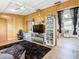 Cozy living room features wood paneling, a large TV, and plenty of storage at 2741 Edwards Rd, Haines City, FL 33844