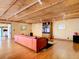 Living room with hardwood floors, exposed beams, and orange couch at 2741 Edwards Rd, Haines City, FL 33844