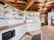Open concept kitchen with exposed beams and a large island at 2741 Edwards Rd, Haines City, FL 33844