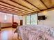 Main bedroom with hardwood floors, exposed beams, and a view at 2741 Edwards Rd, Haines City, FL 33844