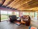 Living area with brick floors, leather furniture, and scenic views from large windows at 2741 Edwards Rd, Haines City, FL 33844
