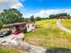 Aerial view shows two houses, a paved driveway, and lush green surroundings at 2741 Edwards Rd, Haines City, FL 33844