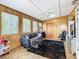 Relaxing living area with a comfortable couch and wood paneled walls at 2741 Edwards Rd, Haines City, FL 33844