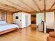 Bedroom with hardwood floors, exposed beams, and ensuite bathroom at 2741 Edwards Rd, Haines City, FL 33844