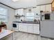 Efficient kitchen with white cabinets, gas stove and patterned refrigerator at 2741 Edwards Rd, Haines City, FL 33844