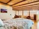 Main bedroom with hardwood floors, exposed beams, and large window at 2741 Edwards Rd, Haines City, FL 33844