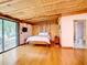 Bedroom with hardwood floors, exposed beams, and sliding glass doors at 2741 Edwards Rd, Haines City, FL 33844