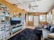 Living room with wood paneling, comfy seating and large TV at 2741 Edwards Rd, Haines City, FL 33844