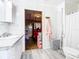 Bathroom with white vanity, toilet, and a view of another room at 2741 Edwards Rd, Haines City, FL 33844