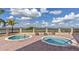 Two hot tubs with lake views and lounge chairs at 4432 Waterford Dr, Lake Wales, FL 33859