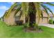 Tan house with palm trees and manicured lawn at 4432 Waterford Dr, Lake Wales, FL 33859