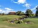 Landscaped golf course with clubhouse and stream at 4432 Waterford Dr, Lake Wales, FL 33859
