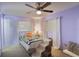 Relaxing bedroom with light purple walls and ceiling fan at 122 Bishop St, Auburndale, FL 33823