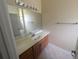 Bathroom boasts a vanity with large mirror and tile floor at 1962 Eloise Cove Dr, Winter Haven, FL 33884