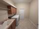 Bright laundry room, washer, dryer, cabinets, and utility sink at 1962 Eloise Cove Dr, Winter Haven, FL 33884