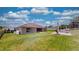 Large backyard with grassy area and patio with grill at 1067 Snively Cir, Lake Hamilton, FL 33851
