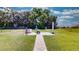 Brick-paved patio area with a fire pit and covered grill at 1067 Snively Cir, Lake Hamilton, FL 33851