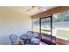 Relaxing screened porch with table and chairs at 1067 Snively Cir, Lake Hamilton, FL 33851