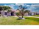 One-story home with a beige exterior, palm trees, and a well-manicured lawn at 1067 Snively Cir, Lake Hamilton, FL 33851