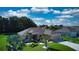 One-story home with a beige exterior, palm trees, and a large backyard at 1067 Snively Cir, Lake Hamilton, FL 33851