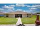 House backyard with a patio and grassy area at 1067 Snively Cir, Lake Hamilton, FL 33851