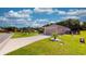 Tan house with a two-car garage and landscaped lawn at 1067 Snively Cir, Lake Hamilton, FL 33851