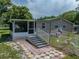 A house with a screened porch, steps, and a fenced yard at 14813 Camp Mack Rd, Lake Wales, FL 33898