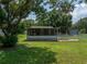 A charming one-story house with a screened porch and well-maintained lawn at 14813 Camp Mack Rd, Lake Wales, FL 33898