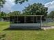 A house with a large screened porch, perfect for outdoor relaxation at 14813 Camp Mack Rd, Lake Wales, FL 33898