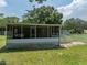 A one-story house with a screened porch and landscaped yard at 14813 Camp Mack Rd, Lake Wales, FL 33898
