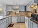 Modern kitchen with white appliances and light-grey cabinets at 14813 Camp Mack Rd, Lake Wales, FL 33898