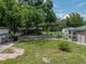 Large grassy backyard with sheds and patio at 14813 Camp Mack Rd, Lake Wales, FL 33898