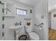 Updated bathroom with pedestal sink, toilet, and grab bars at 14813 Camp Mack Rd, Lake Wales, FL 33898
