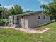 Tan house with green roof, walkway, and spacious yard at 14813 Camp Mack Rd, Lake Wales, FL 33898
