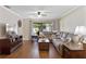 Inviting living room with plush sectional sofa, wood floors, and sliding glass doors to the backyard at 1521 Oakview Se Cir, Winter Haven, FL 33880