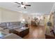Open concept living and dining area with wood floors, view of the kitchen and dining table at 1521 Oakview Se Cir, Winter Haven, FL 33880