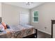Bedroom with patterned comforter, ceiling fan, large window, and closet at 329 Lake Vista Dr, Auburndale, FL 33823