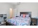 A cozy bedroom with patterned bedding, nightstand, and storage unit at 329 Lake Vista Dr, Auburndale, FL 33823