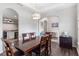 Formal dining space with a wooden table, seating for six, and arched doorways at 329 Lake Vista Dr, Auburndale, FL 33823