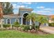 Charming blue two-story home with lush landscaping and a welcoming front entrance at 329 Lake Vista Dr, Auburndale, FL 33823