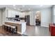 Open kitchen with white cabinetry, stainless appliances, an island with bar seating, and tile floors at 329 Lake Vista Dr, Auburndale, FL 33823