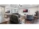 Open-concept living room with comfortable seating, a large TV, and views of the adjacent kitchen at 329 Lake Vista Dr, Auburndale, FL 33823