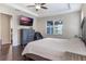 Spacious main bedroom with ceiling fan, TV, and access to the bathroom at 329 Lake Vista Dr, Auburndale, FL 33823