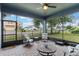 Screened porch with pavers, ceiling fan, and neighborhood view at 329 Lake Vista Dr, Auburndale, FL 33823